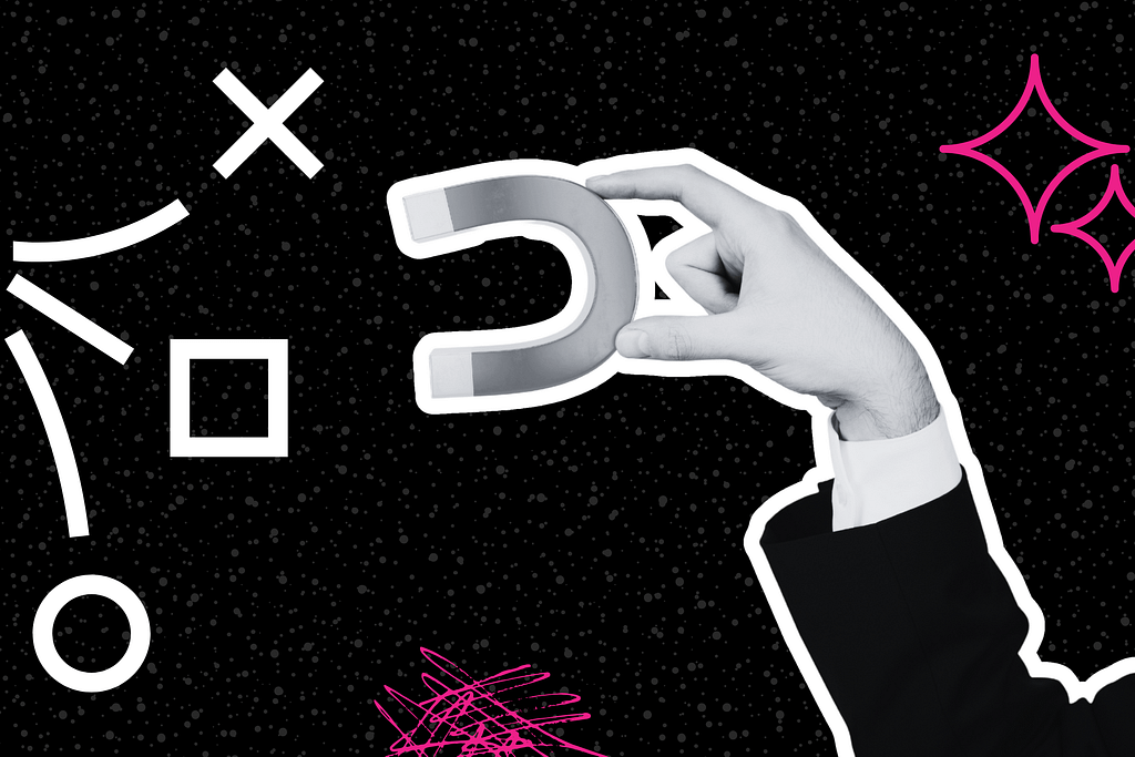 A hand in a suit holds a horseshoe magnet against a black background with abstract white and pink geometric shapes.