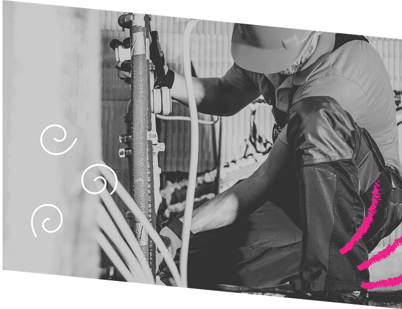 Worker in safety gear adjusts pipes outdoors, with swirly designs and pink brushstrokes on the image border.